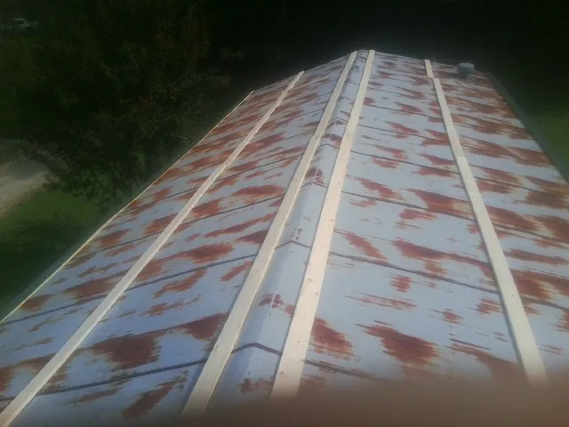 Rusted metal roof panels with new wood purlins before replacement — Storm Damage Roof Repair in Vintondale by Roofing Brothers