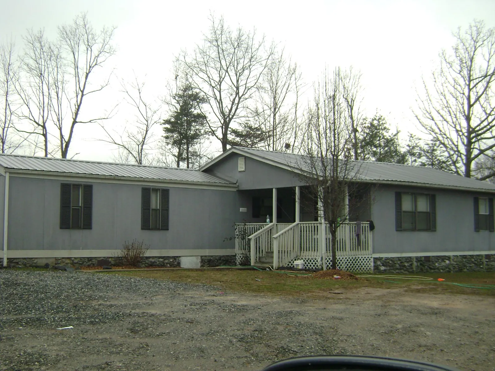 Metal roof over a manufactured home with a covered front porch in Vintondale