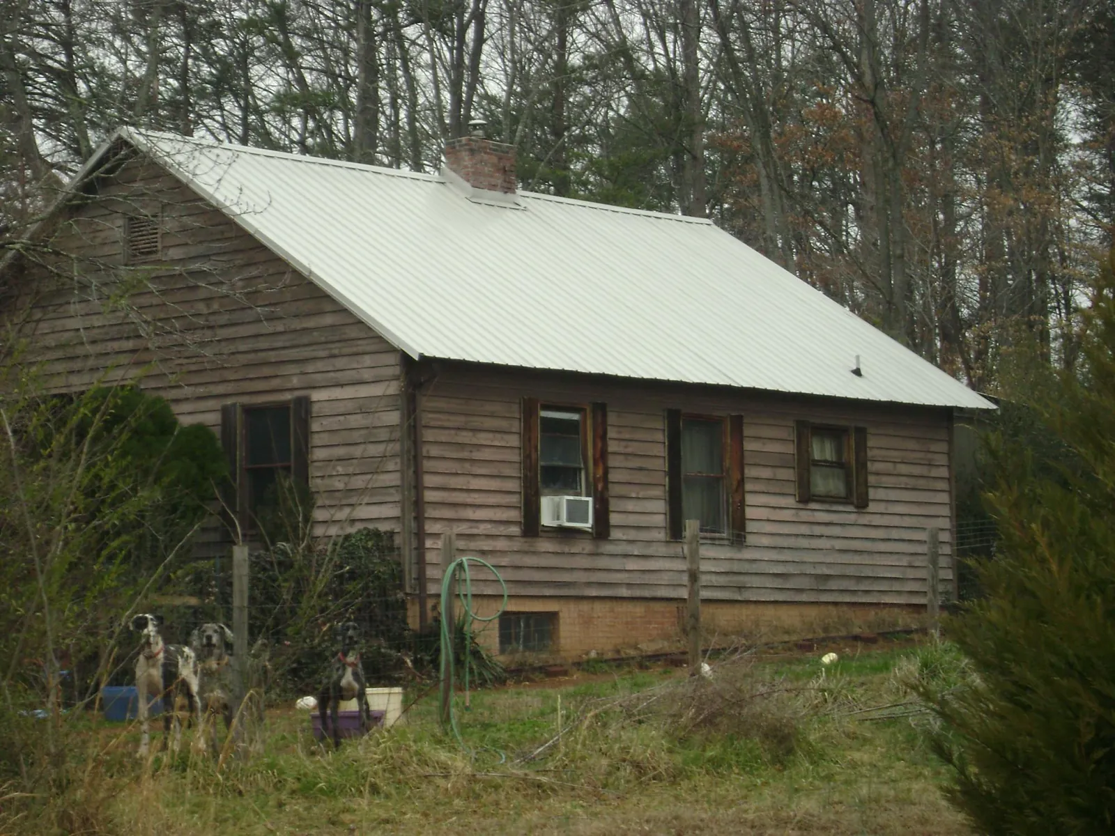 White metal roof on an old wood sided farmhouse, from a Metal Roof Installation job in Vintondale